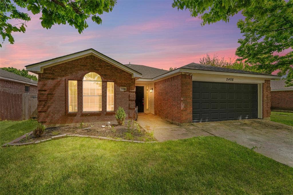 2408 Castle Ridge Drive, McKinney, TX 75071 Ranch-style house with an attached garage, brick siding, and driveway