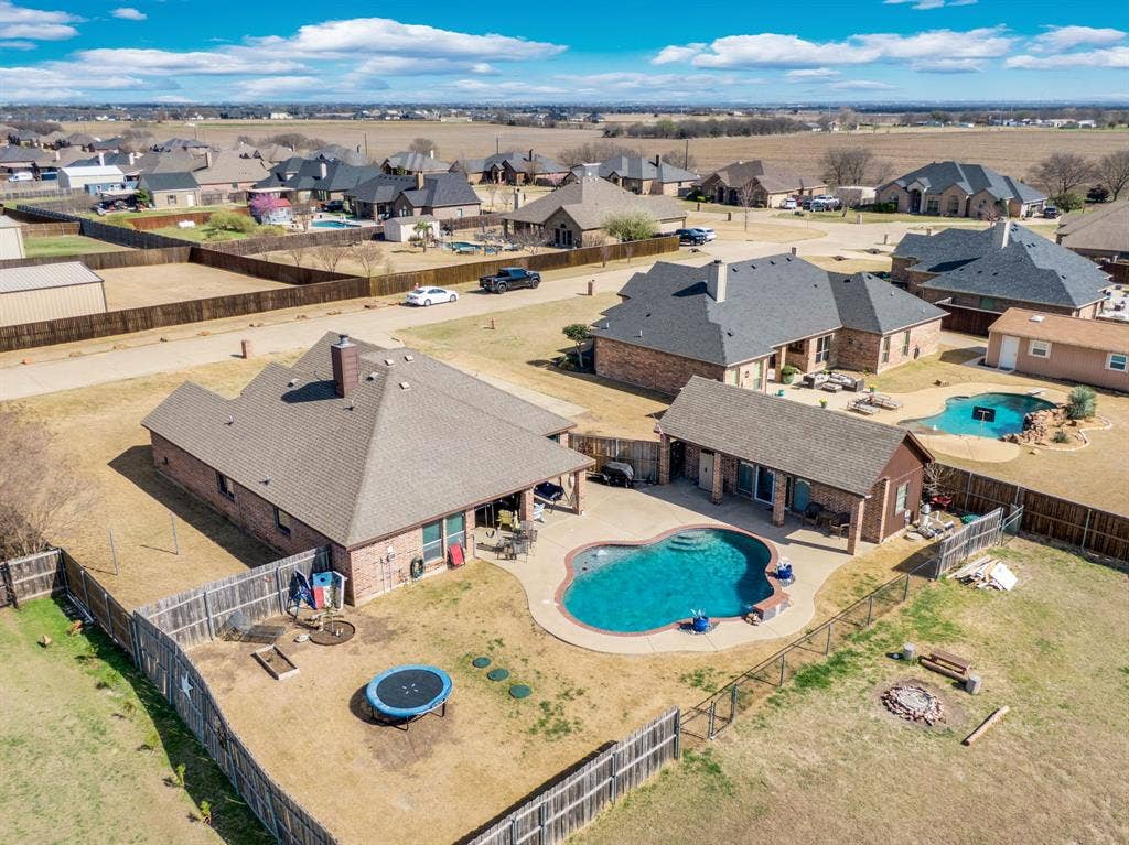 160 Berkshire Lane, Waxahachie, TX 75165 Aerial perspective of suburban area featuring a pool