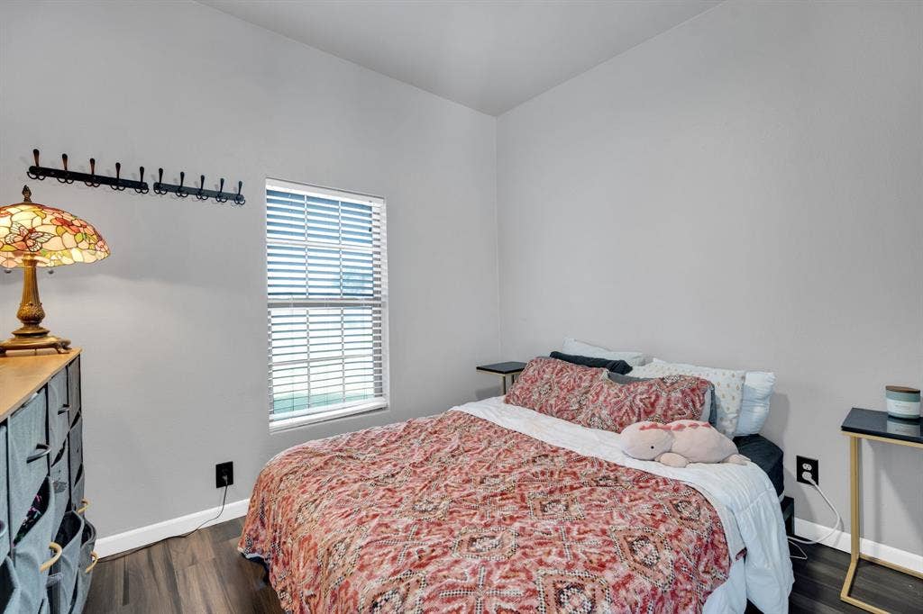 160 Berkshire Lane, Waxahachie, TX 75165 Room featuring wood-finish flooring, light gray walls, a window with horizontal blinds, and baseboard trim