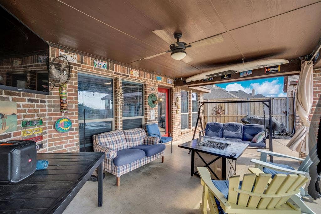160 Berkshire Lane, Waxahachie, TX 75165 Fenced backyard with an outdoor living space with a fire pit, ceiling fan, and a patio area