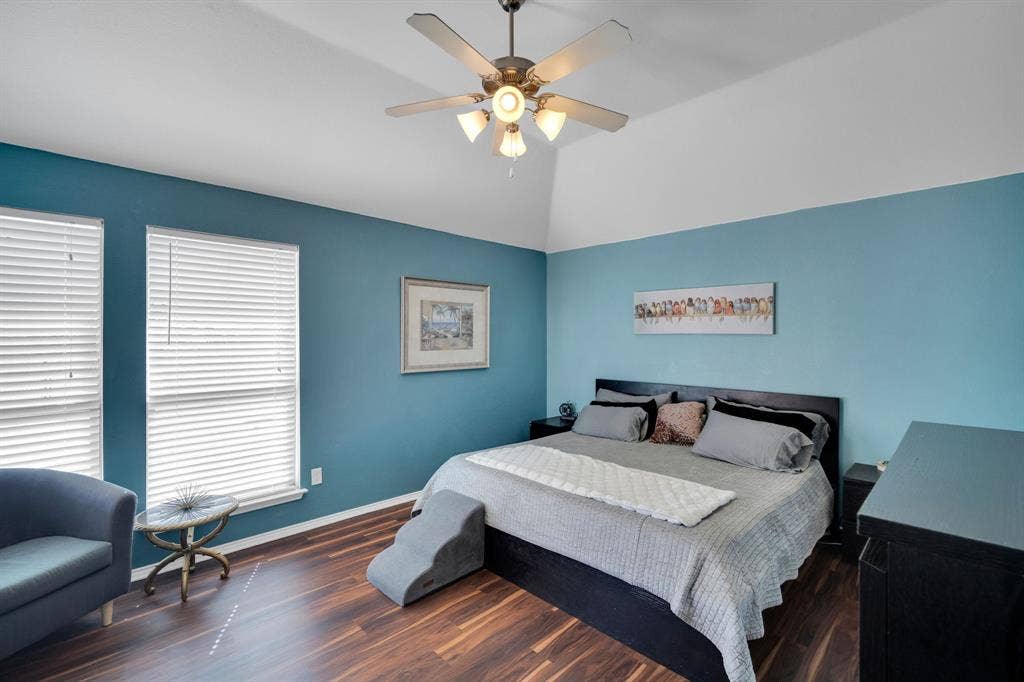 160 Berkshire Lane, Waxahachie, TX 75165 Spacious room featuring vaulted ceilings, wood-finish flooring, and two large windows with blinds