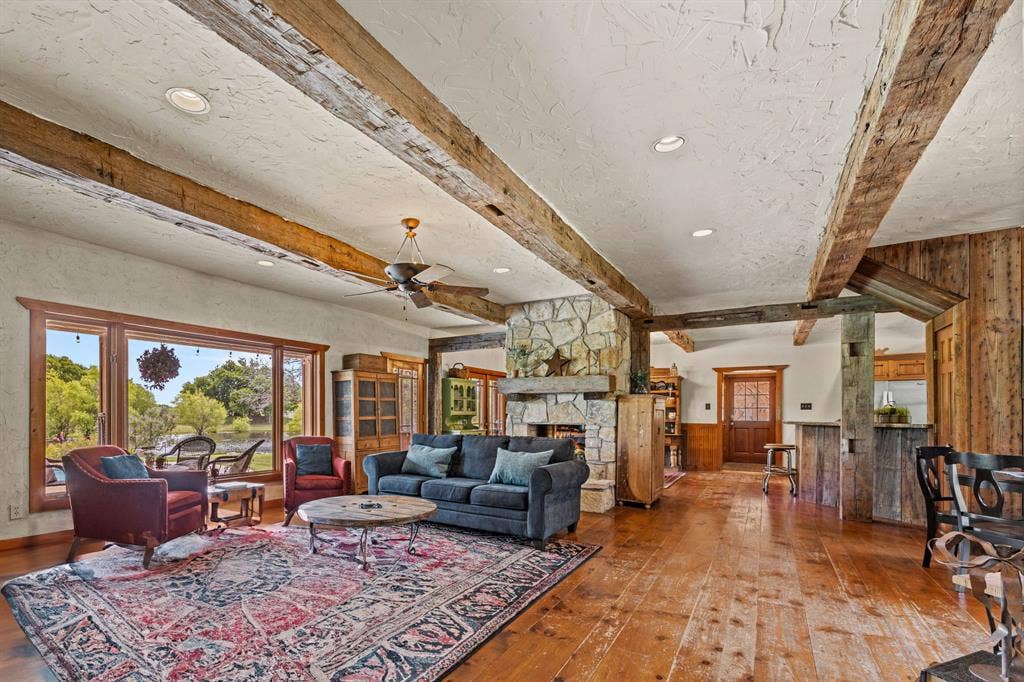 535 Cullins Road E, Rockwall, TX 75032 Recently re-stained soft pine floors, massive solid oak beamed ceilings & a see-thru fireplace that adds warmth & character to the newly-painted kitchen