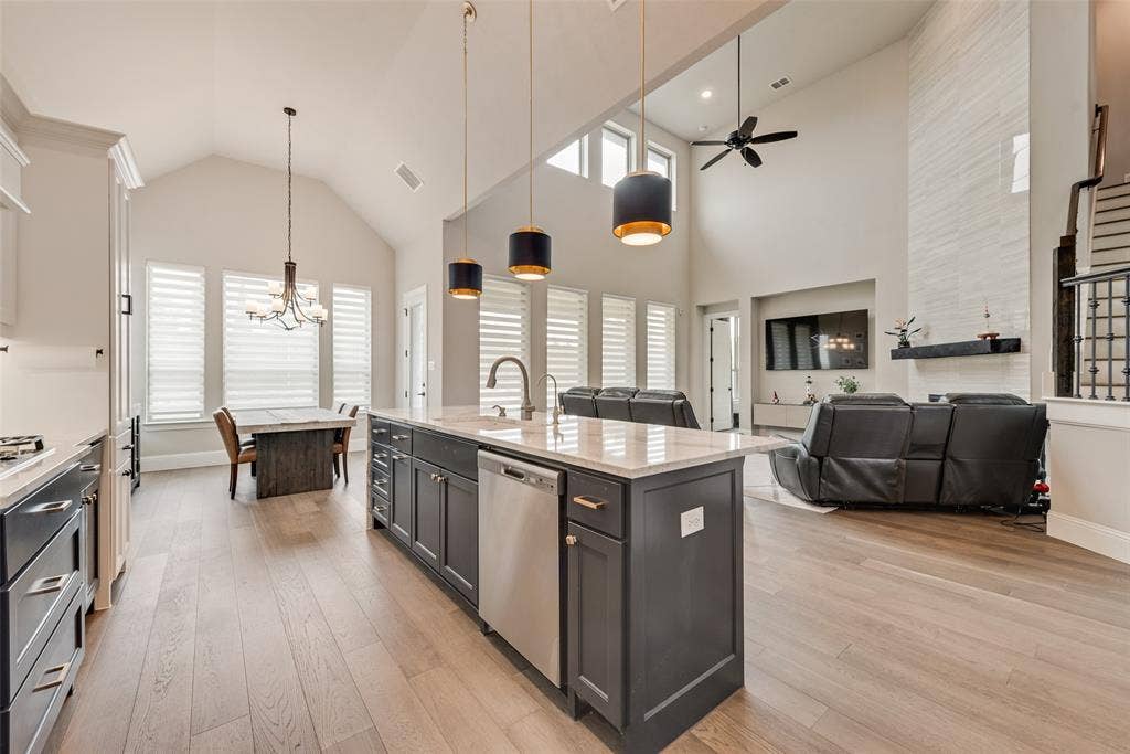 7108 Woodside Drive, Argyle, TX 76226 decorative lights, vaulted ceiling chef's kitchen overlooking living room and breakfast area
