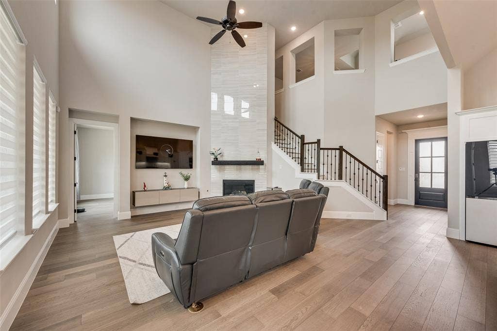 7108 Woodside Drive, Argyle, TX 76226 striking gas log tile decorated fire place extending to a tall ceiling