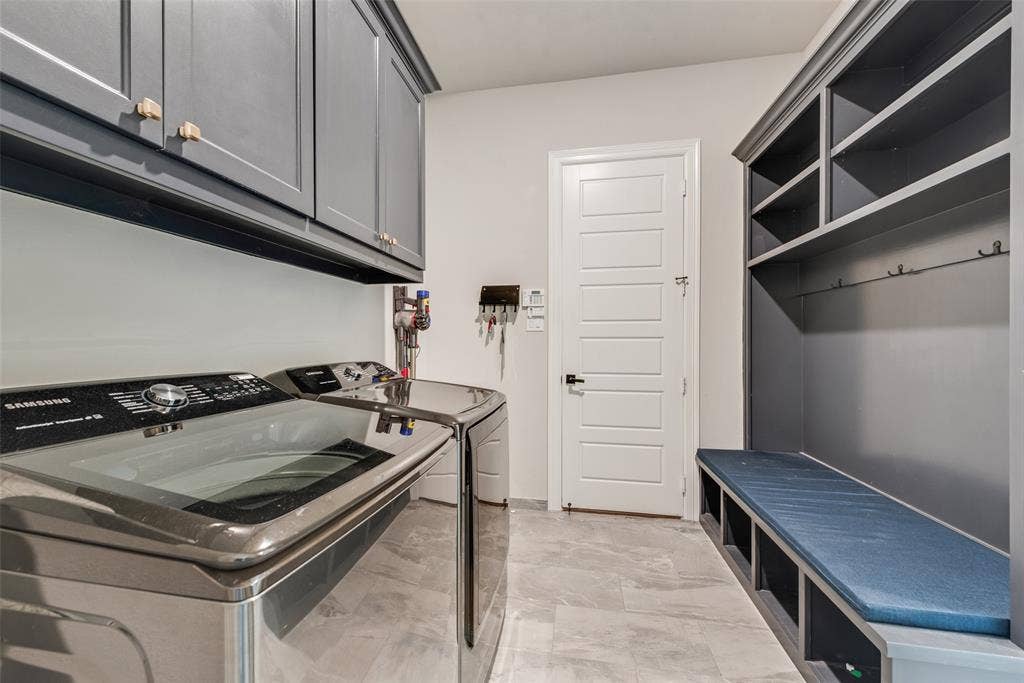 7108 Woodside Drive, Argyle, TX 76226 utility room with mud bench, cabinet, & extra room for freezer