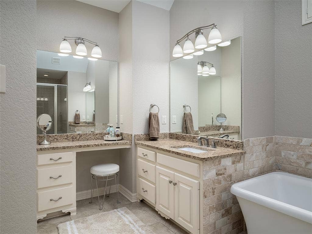 1137 Ashwood Drive, Tyler, TX 75703 Double sinks, makeup vanity area, granite countertops, stand alone tub, and gorgeous brick look tiles!