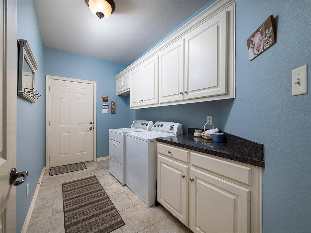 1137 Ashwood Drive, Tyler, TX 75703 Lots of cabinets for storage in the large laundry room.