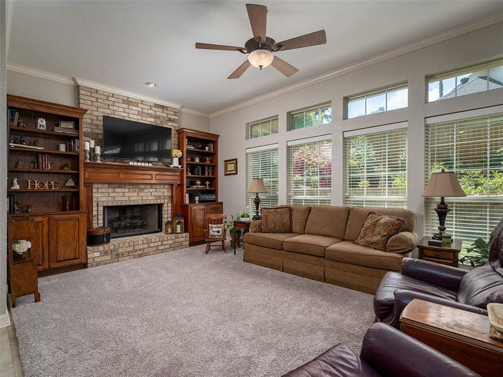 1137 Ashwood Drive, Tyler, TX 75703 Den features a Brick fireplace, oodles of light, built-ins and is very spacious.