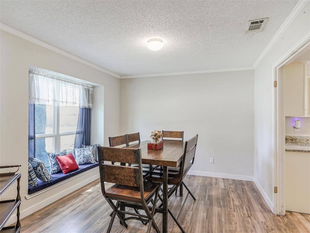 317 Stillmeadow Drive, Garland, TX 75040 Bathed in natural light, this dining space feels warm and welcoming. The window seat adds charm and versatility—perfect for slow mornings, casual meals, or simply a spot to sit and take in the day.