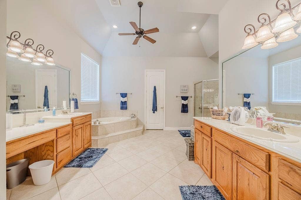 1011 Parview Circle, Grand Prairie, TX 75104 Bathroom with a garden tub, two vanities, a shower stall, light tile patterned floors, and recessed lighting