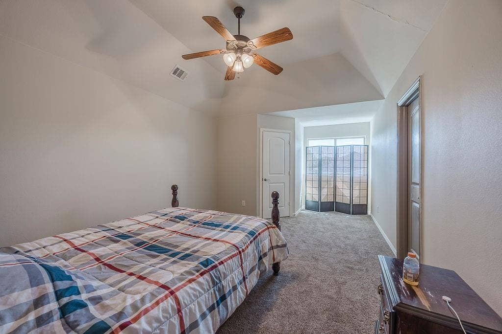 1011 Parview Circle, Grand Prairie, TX 75104 Carpeted bedroom featuring ceiling fan and lofted ceiling