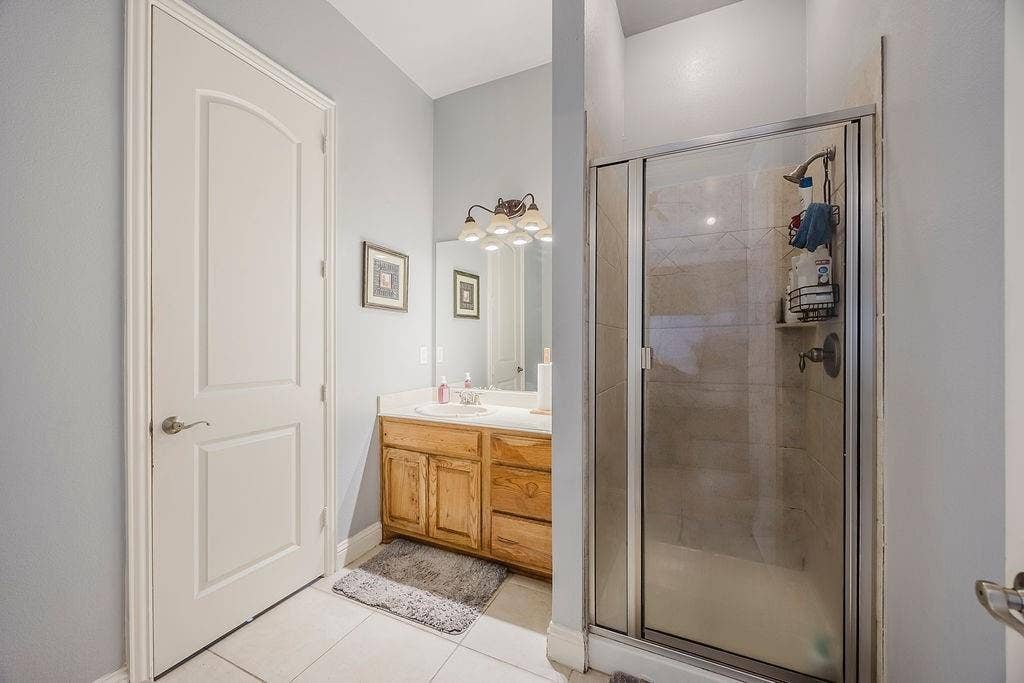 1011 Parview Circle, Grand Prairie, TX 75104 Bathroom with a stall shower, vanity, and light tile patterned floors