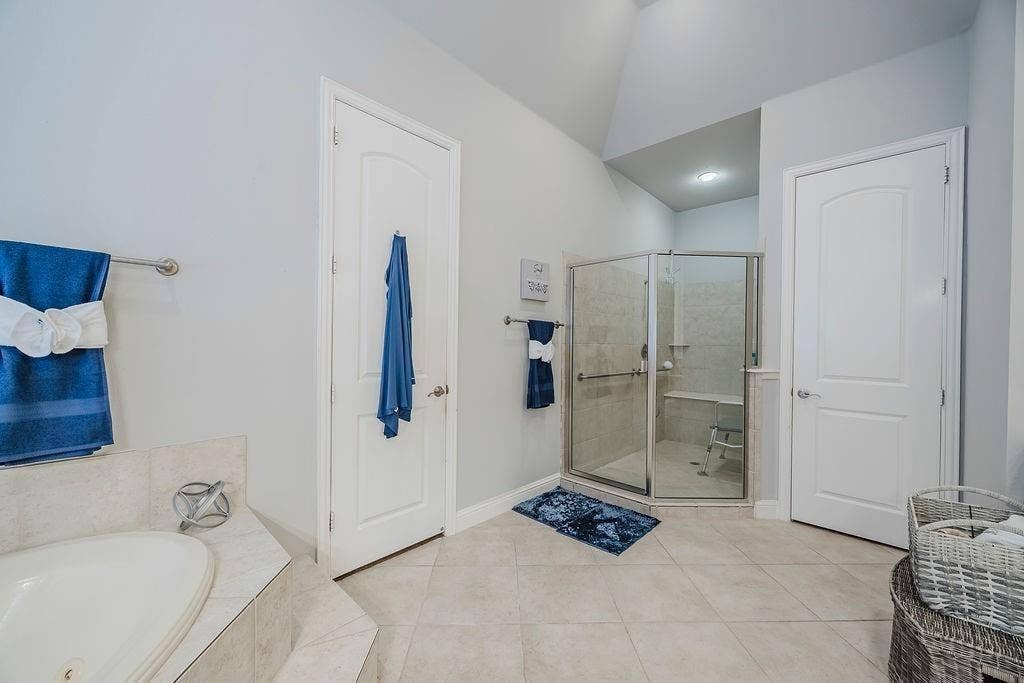 1011 Parview Circle, Grand Prairie, TX 75104 Full bath with a garden tub, light tile patterned flooring, and a shower stall