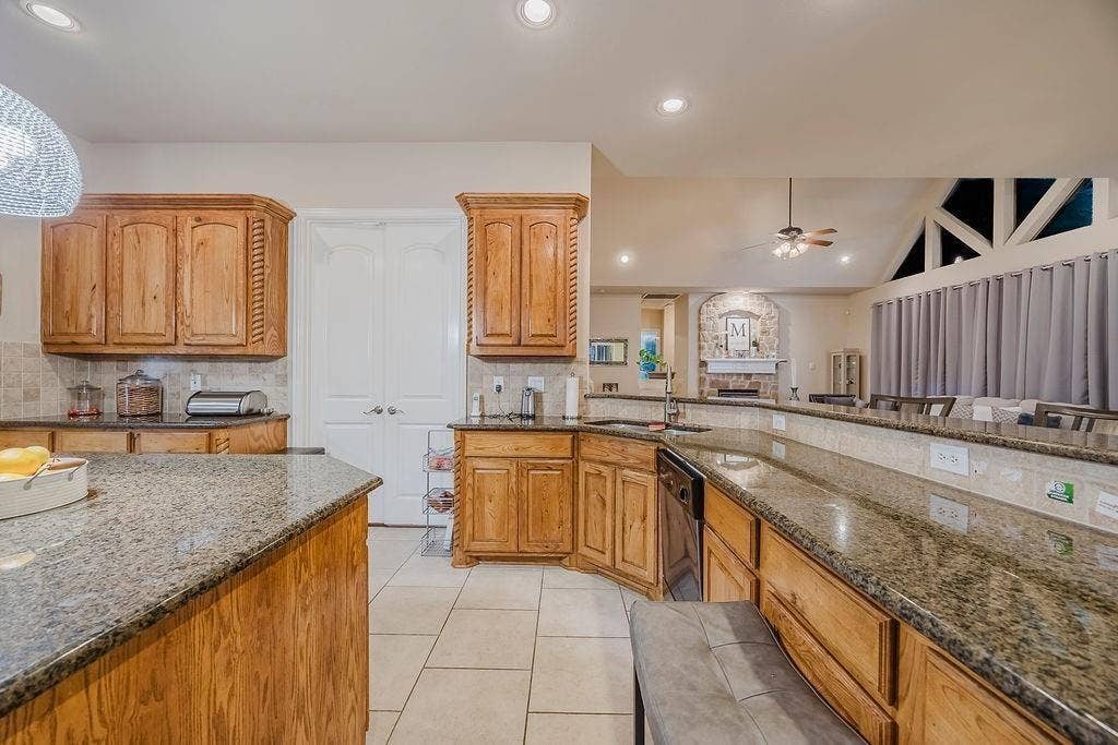 1011 Parview Circle, Grand Prairie, TX 75104 Kitchen with granite counters, ceiling fan, wood finish cabinetry, and recessed lighting