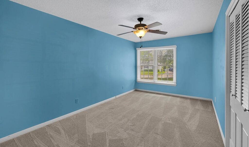 3917 Morrow Avenue, Waco, TX 76710 Spare room with light colored carpet, ceiling fan, and a textured ceiling