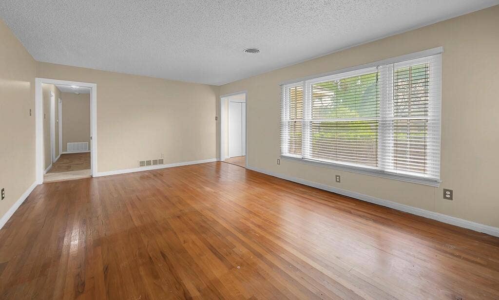 3917 Morrow Avenue, Waco, TX 76710 Unfurnished room featuring light wood-style floors and a textured ceiling