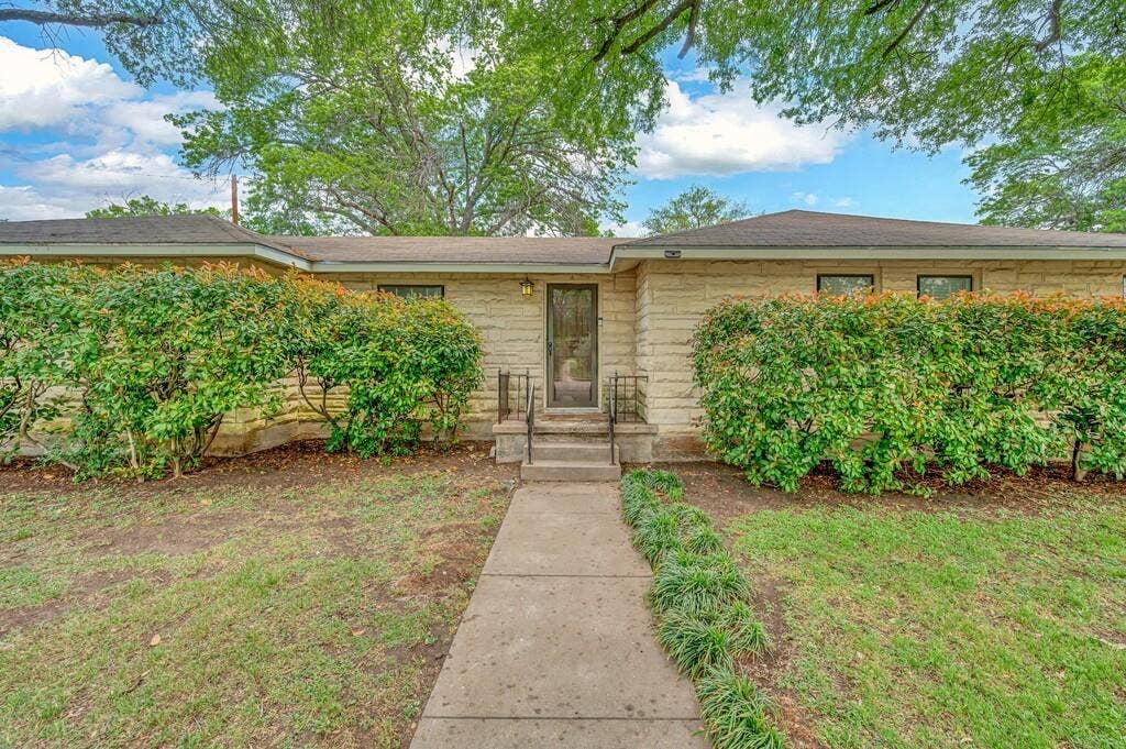 3917 Morrow Avenue, Waco, TX 76710 View of front of property featuring a front lawn and stone siding