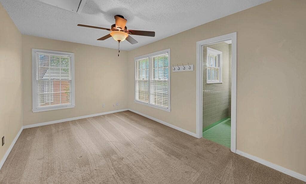 3917 Morrow Avenue, Waco, TX 76710 Empty room with a textured ceiling, light carpet, and ceiling fan