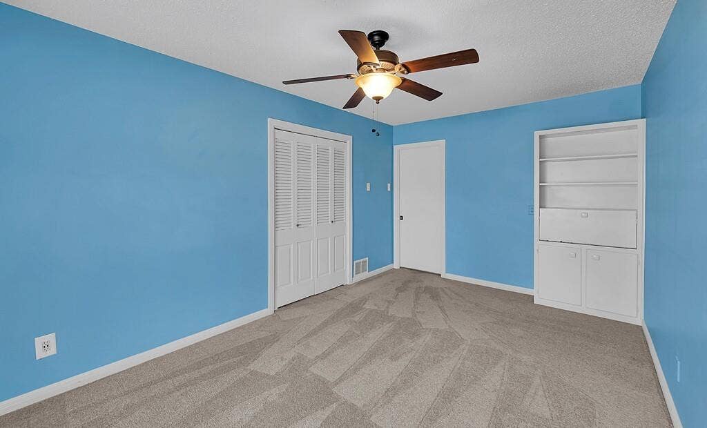 3917 Morrow Avenue, Waco, TX 76710 Unfurnished bedroom featuring light carpet, a textured ceiling, ceiling fan, and a closet