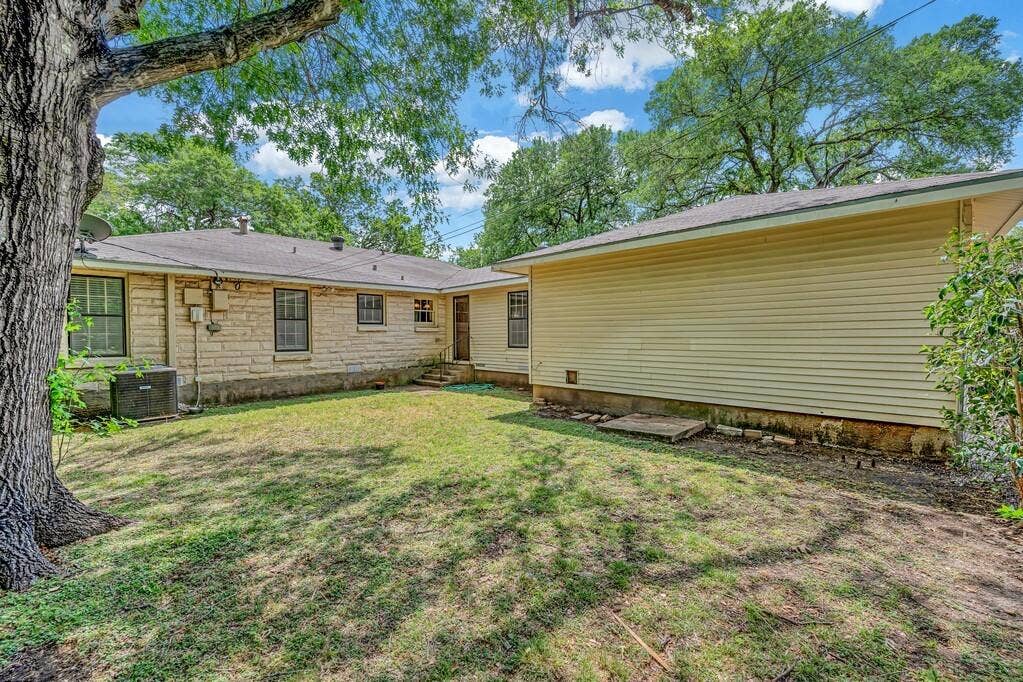3917 Morrow Avenue, Waco, TX 76710 Back of property featuring a lawn