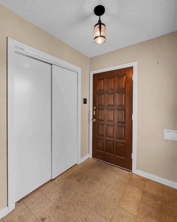 3917 Morrow Avenue, Waco, TX 76710 Foyer with baseboards and a textured ceiling