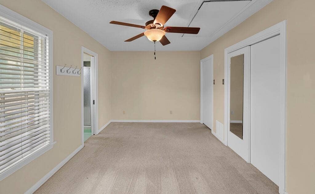 3917 Morrow Avenue, Waco, TX 76710 Unfurnished bedroom with a ceiling fan, french doors, light carpet, and a closet
