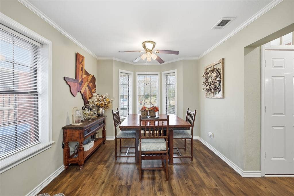 820 Torribrooke Lane, Athens, TX 75751 Dining area featuring ornamental molding, a ceiling fan, and dark wood-style flooring