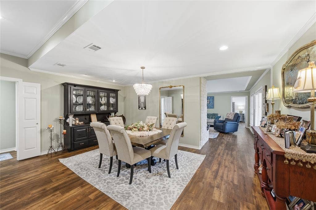 820 Torribrooke Lane, Athens, TX 75751 Dining space featuring ornamental molding, a chandelier, and dark wood finished floors