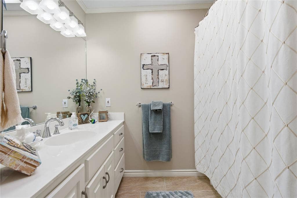 820 Torribrooke Lane, Athens, TX 75751 Bathroom featuring crown molding, vanity, and a shower with curtain