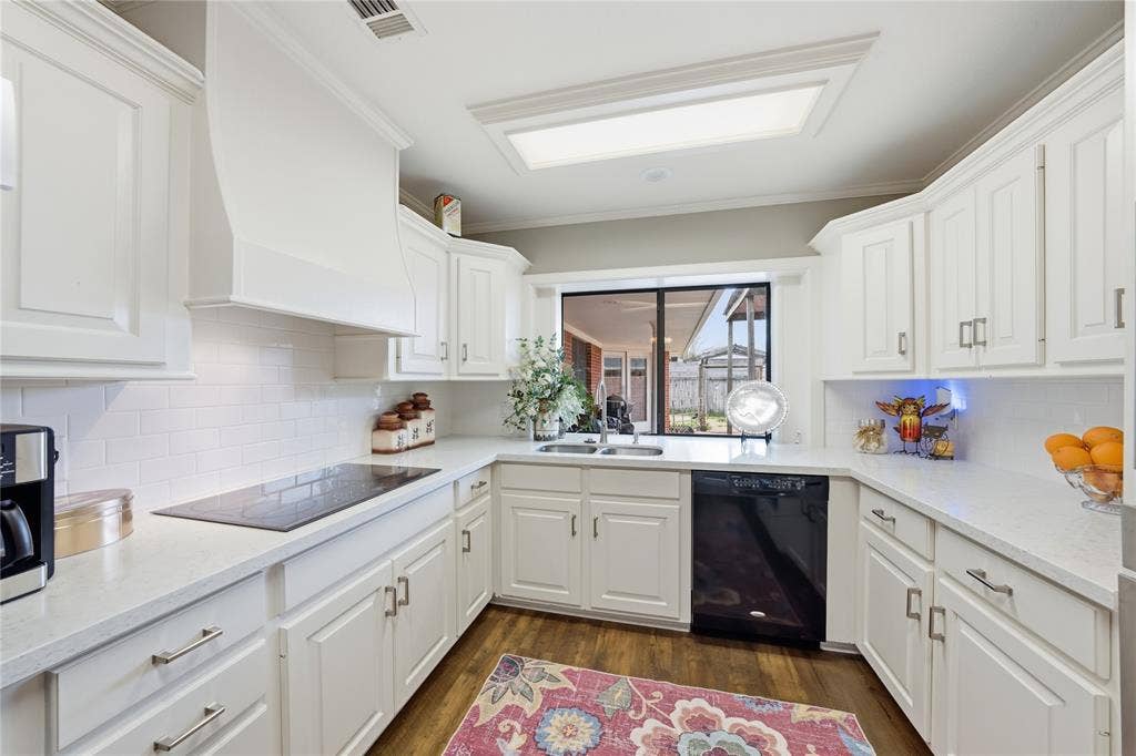 820 Torribrooke Lane, Athens, TX 75751 Kitchen featuring white cabinetry, black appliances, backsplash, dark wood-type flooring, and crown molding