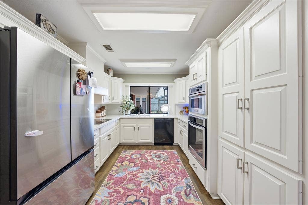 820 Torribrooke Lane, Athens, TX 75751 Kitchen featuring black appliances, light countertops, white cabinetry, and dark wood-style flooring