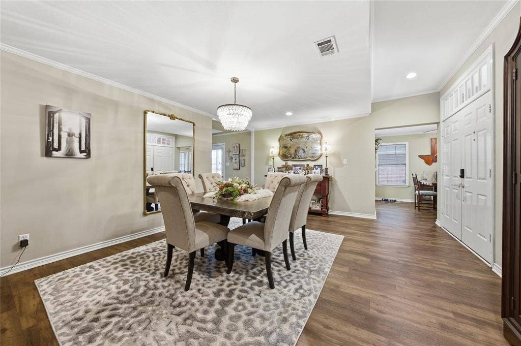820 Torribrooke Lane, Athens, TX 75751 Dining space with ornamental molding, a chandelier, and dark wood-style floors