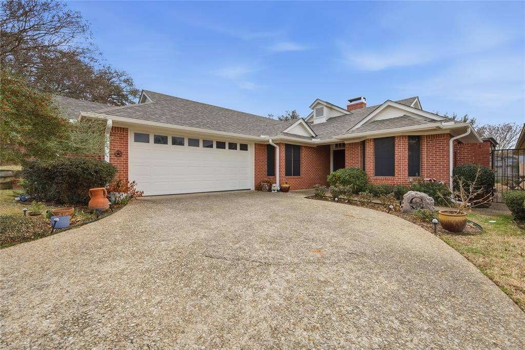 820 Torribrooke Lane, Athens, TX 75751 Ranch-style house featuring driveway, a shingled roof, an attached garage, and brick siding