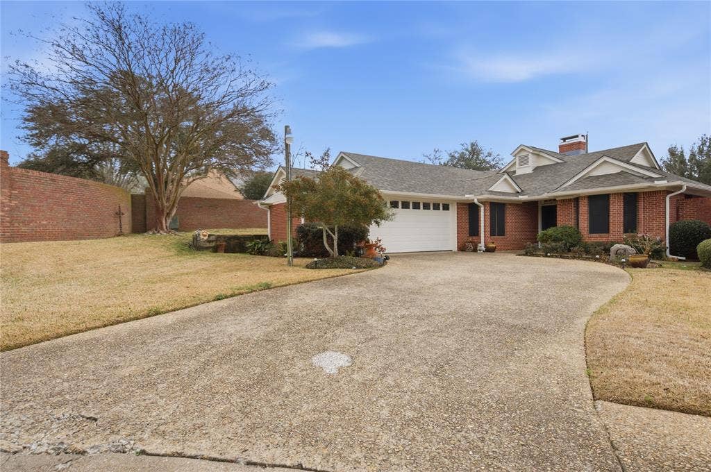 820 Torribrooke Lane, Athens, TX 75751 View of front of property with brick siding, an attached garage, roof with shingles, driveway, and a front lawn