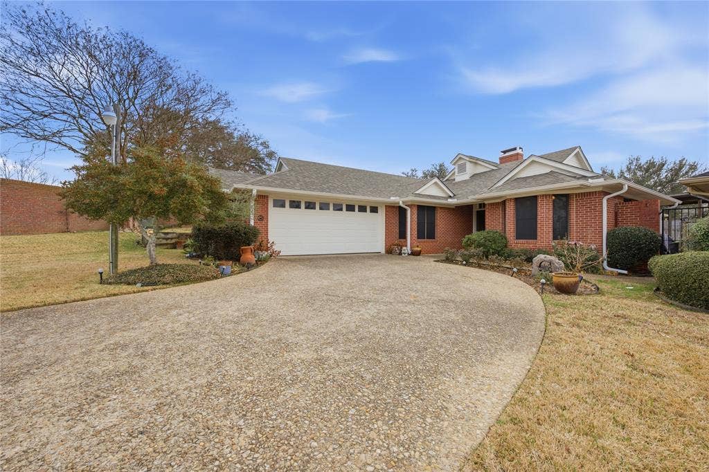 820 Torribrooke Lane, Athens, TX 75751 View of front facade with an attached garage, a shingled roof, a front lawn, and driveway