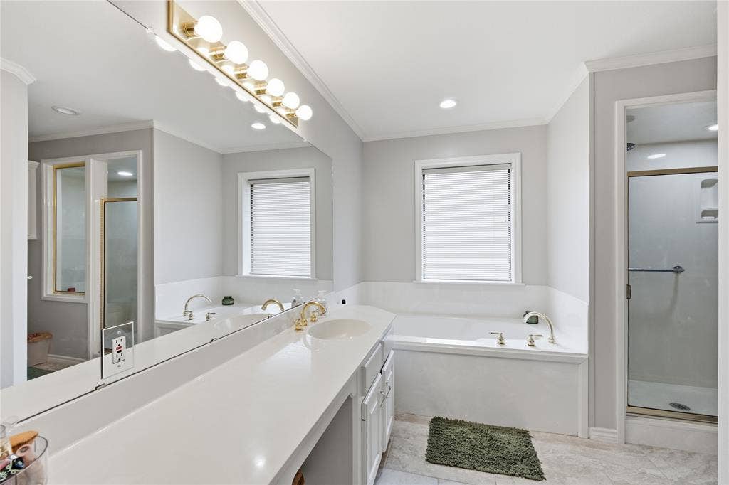 820 Torribrooke Lane, Athens, TX 75751 Bathroom with a stall shower, a garden tub, vanity, ornamental molding, and plenty of natural light