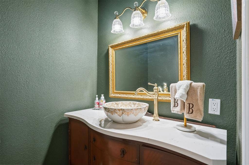 451 Land Of Goshen Drive, Springtown, TX 76082 Custom vanity featuring a vessel sink, gold-tone faucet, and ornate gold-framed mirror