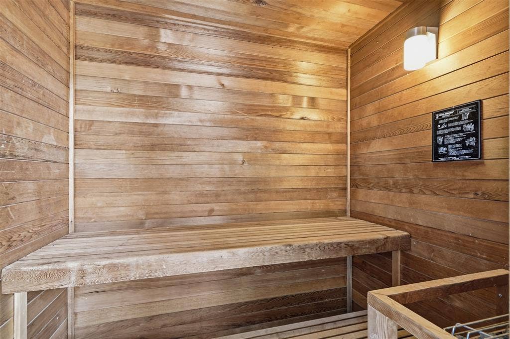 451 Land Of Goshen Drive, Springtown, TX 76082 Sauna featuring natural wood paneling, built-in wooden benches, and a wall-mounted light fixture