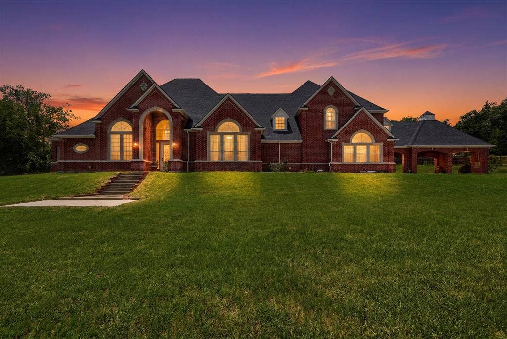 451 Land Of Goshen Drive, Springtown, TX 76082 Expansive brick residence featuring a multi-gabled roofline and covered porte-cochère