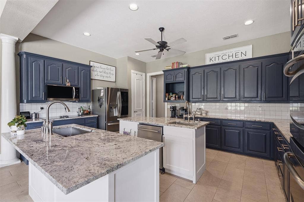 451 Land Of Goshen Drive, Springtown, TX 76082 Kitchen featuring two islands with stone countertops, blue cabinetry, tile flooring, and recessed lighting