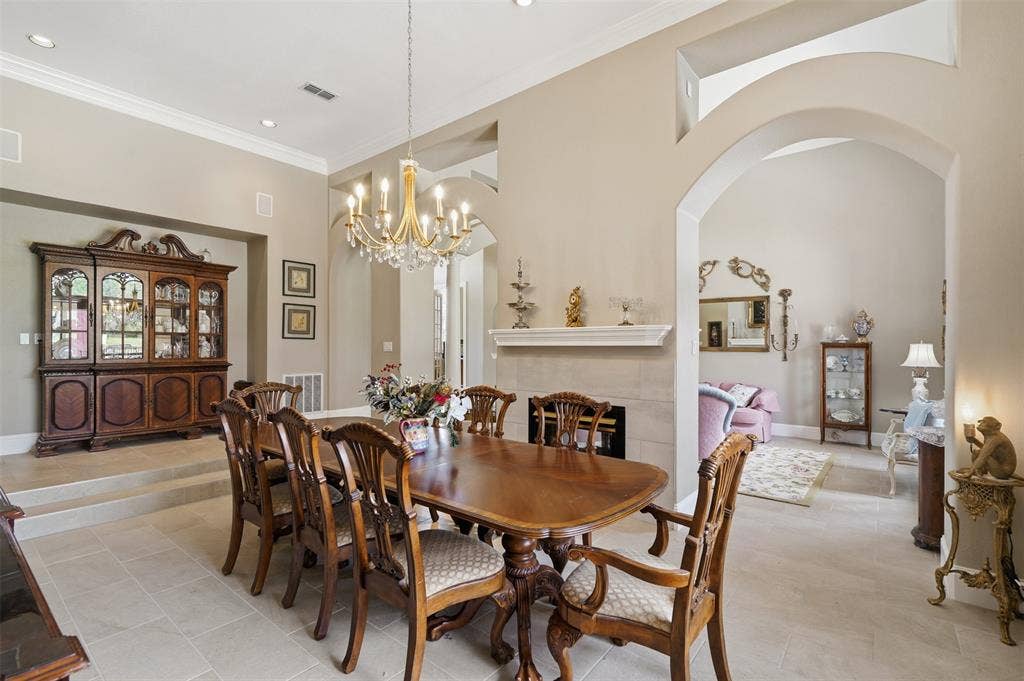 451 Land Of Goshen Drive, Springtown, TX 76082 Dining area featuring tile flooring, a tiered ceiling, and an ornate chandelier
