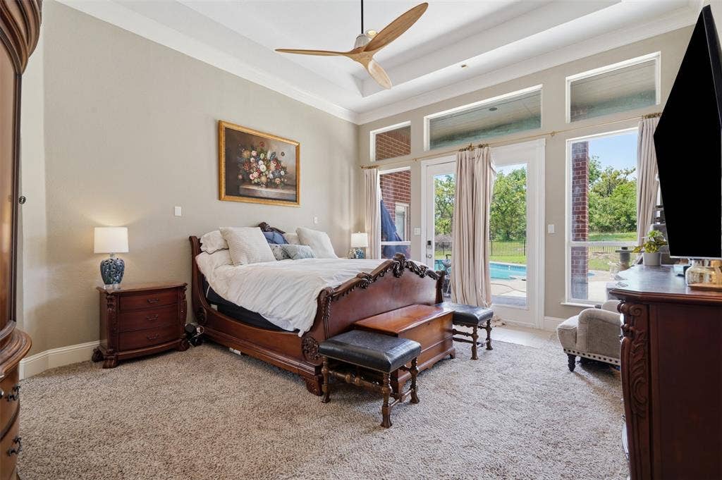 451 Land Of Goshen Drive, Springtown, TX 76082 Carpeted bedroom featuring a contemporary ceiling fan and tray ceiling