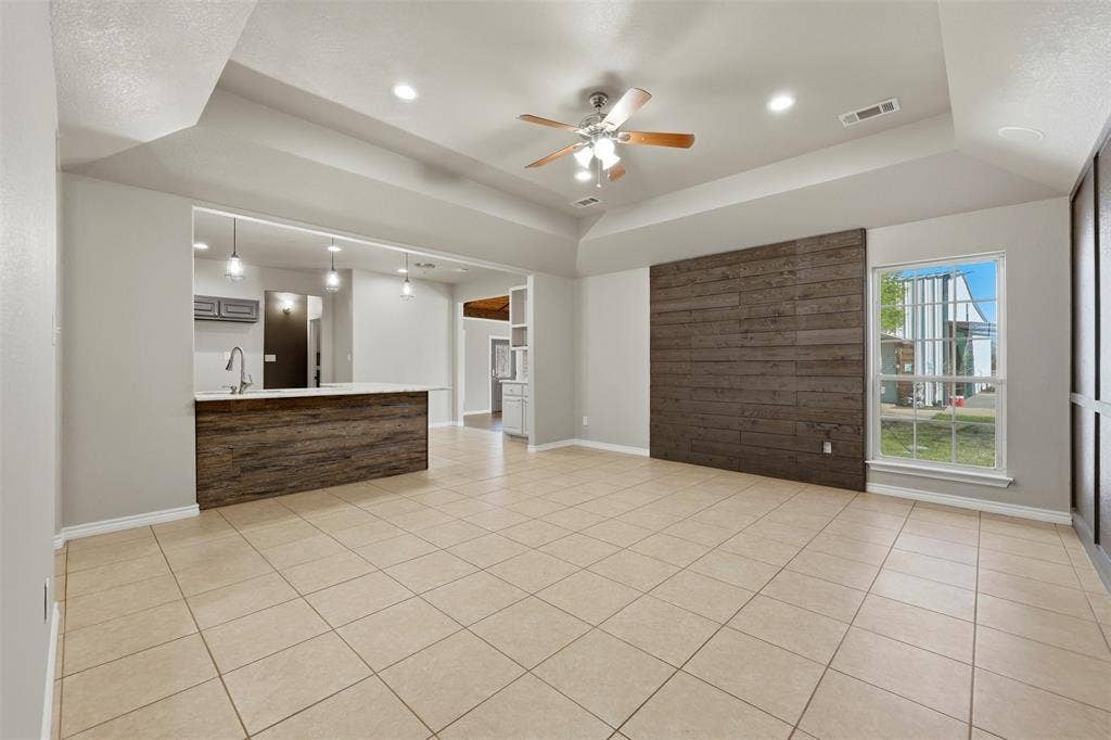 113 Mulkey Road, Waxahachie, TX 75167 living room featuring a ceiling fan, light tile patterned flooring, recessed lighting, and a raised ceiling