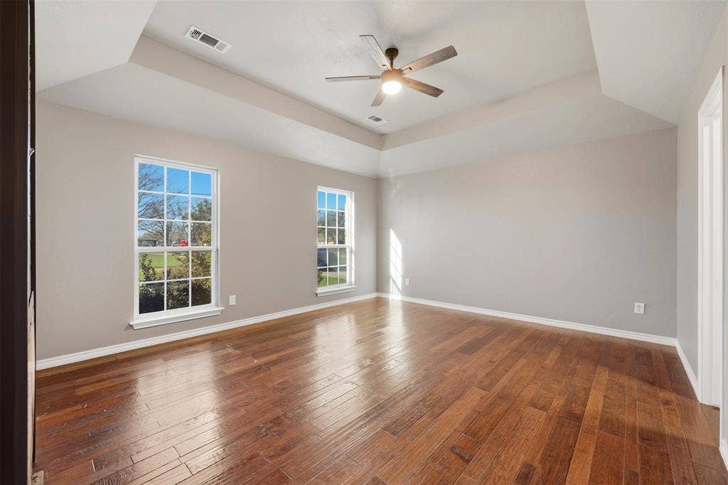 113 Mulkey Road, Waxahachie, TX 75167 room featuring a raised ceiling, a ceiling fan, and dark wood finished floors