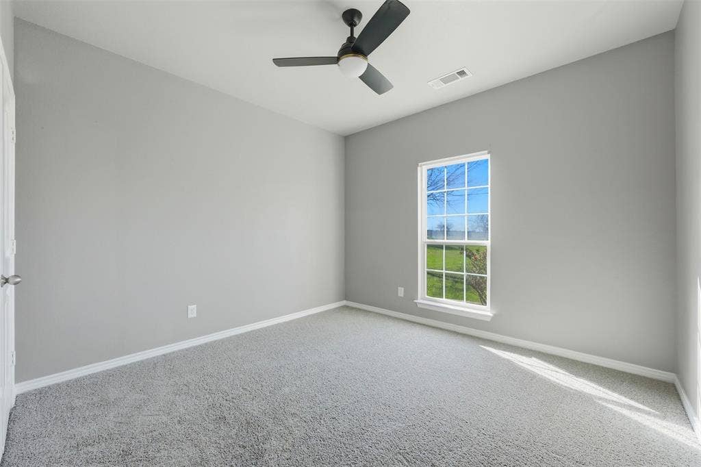 113 Mulkey Road, Waxahachie, TX 75167 Spare room featuring carpet floors and a ceiling fan