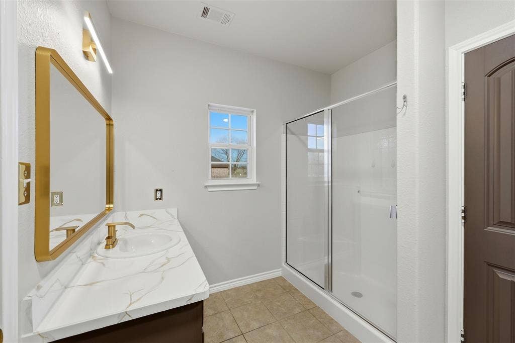 113 Mulkey Road, Waxahachie, TX 75167 Bathroom with vanity, a stall shower, and light tile patterned floors