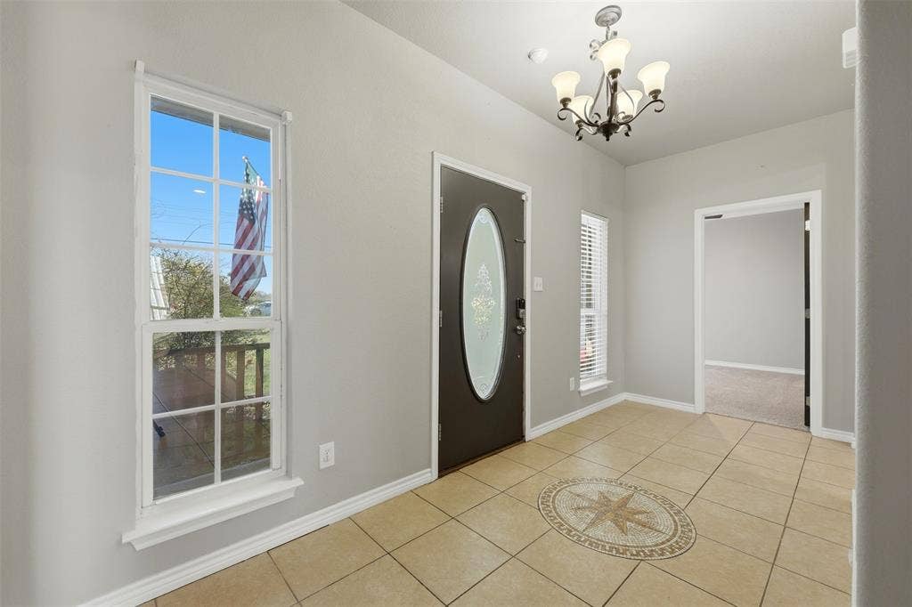 113 Mulkey Road, Waxahachie, TX 75167 Foyer with light tile patterned floors and suspended lighting