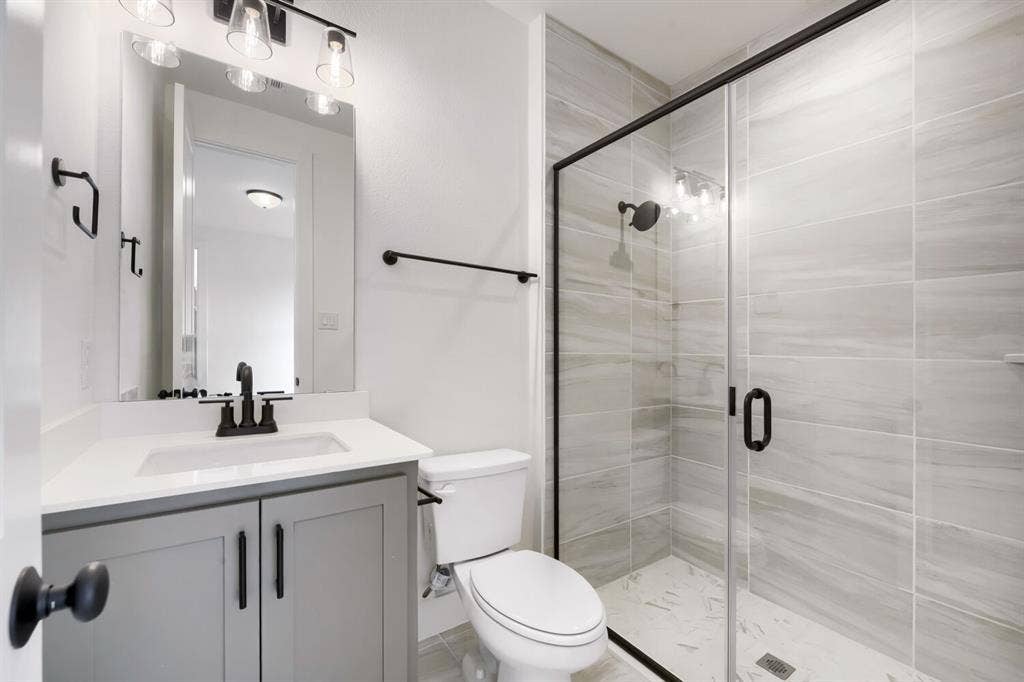 733 Red Cedar Road, Haslet, TX 76052 Bathroom featuring a glass-enclosed shower with tiled walls and a tiled floor