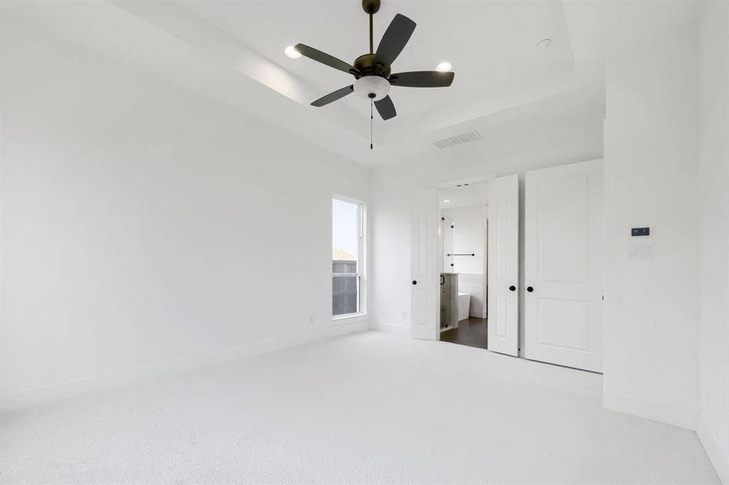 733 Red Cedar Road, Haslet, TX 76052 Spacious room featuring white carpeting, a tray ceiling with a ceiling fan, and a single window
