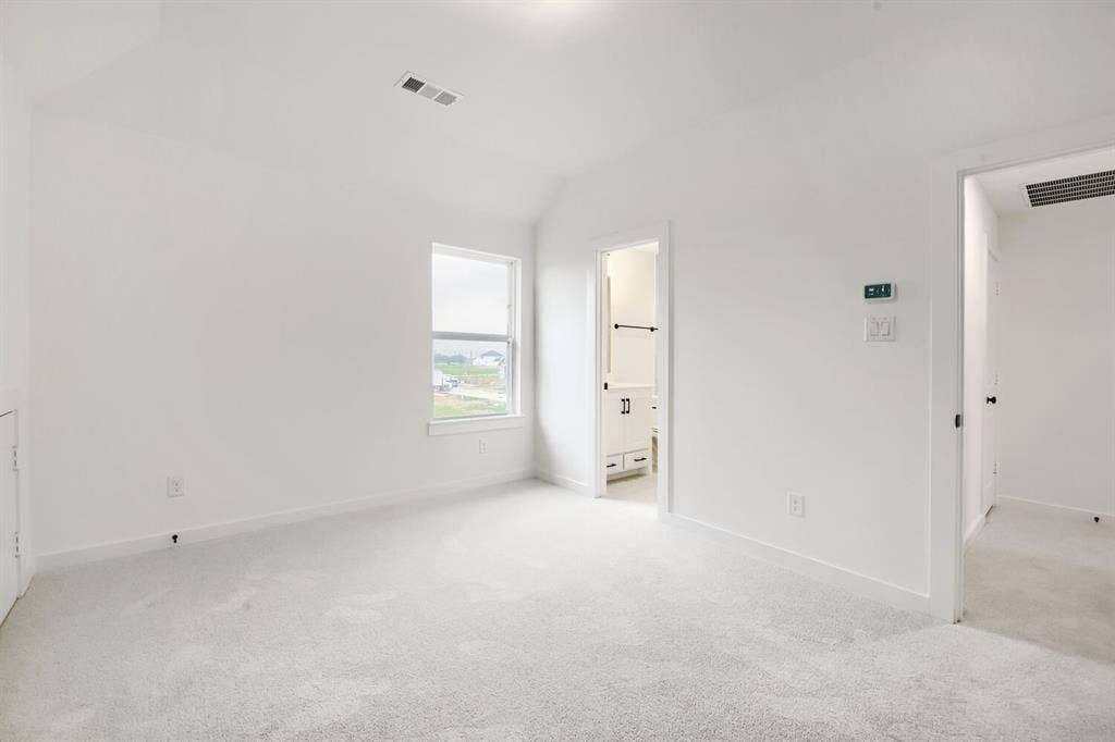 733 Red Cedar Road, Haslet, TX 76052 Vaulted ceiling room with light-colored carpeting, white baseboards, and a single-pane window